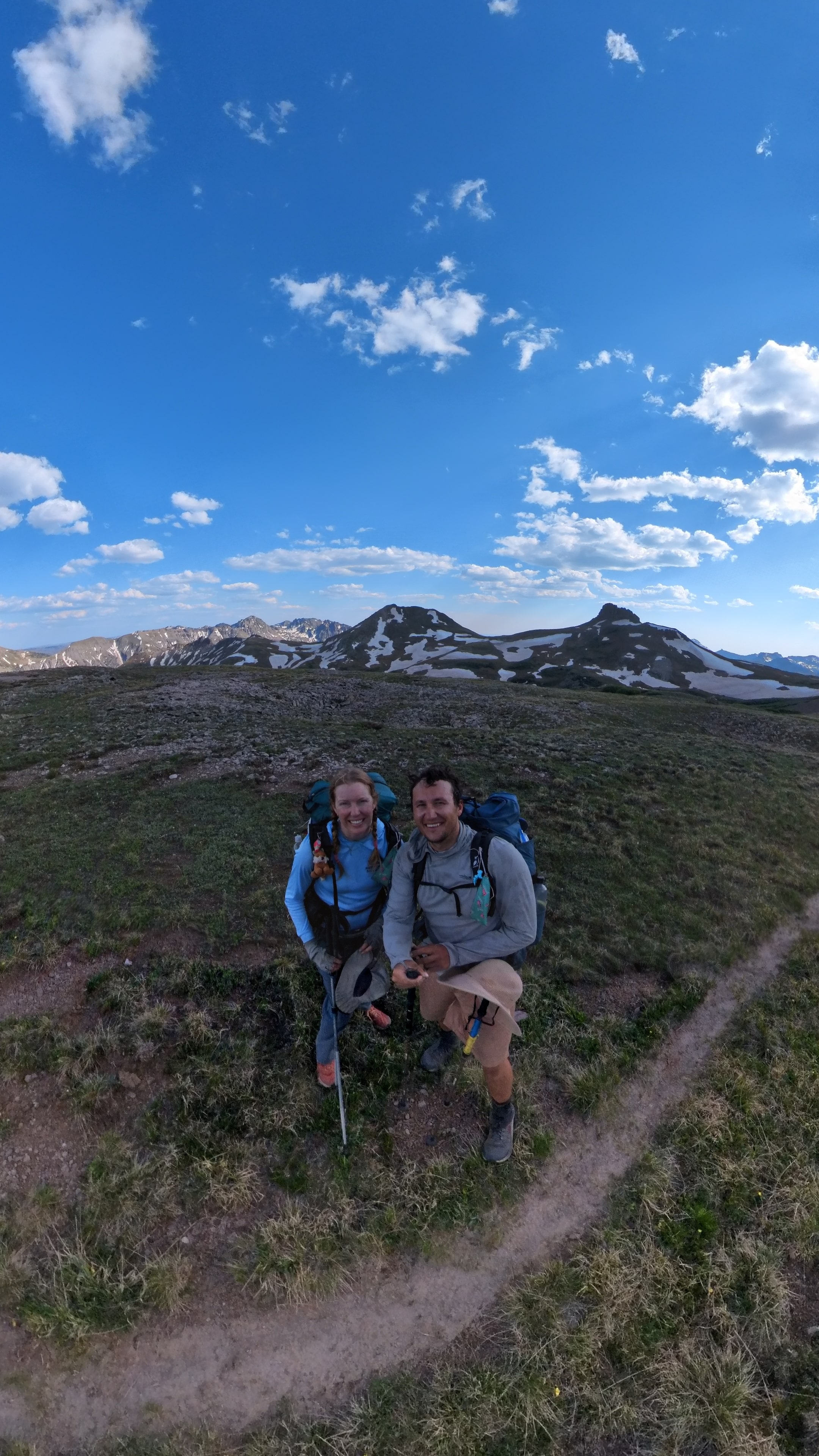 Victory pose on mountain summit with endless views